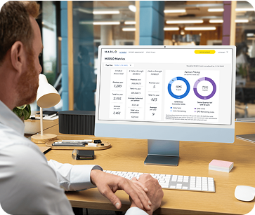 A doctor working on a desktop computer looking at his MARLO dashboard data and analytics.